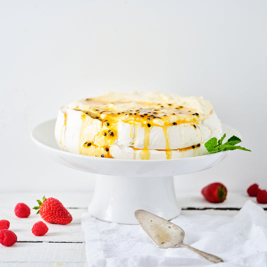 PAVLOVA, BERRIES, WHIPPED CREAM, PASSIONFRUIT SAUCE.